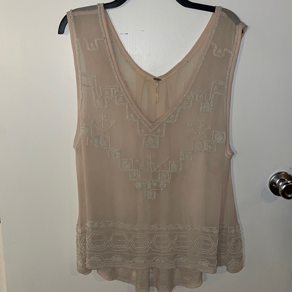 Woman’s nude beaded blouse